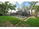 Inviting backyard with a screened-in pool area surrounded by a well-maintained lawn and ample space for outdoor activities at 934 Deerwood Loop, Longwood, FL 32779