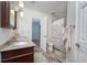 Bathroom featuring a double vanity, wood-look flooring, and a shower with a floral curtain at 934 Deerwood Loop, Longwood, FL 32779