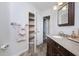 Bathroom features a granite countertop, wood-look flooring, and shelving for linens at 934 Deerwood Loop, Longwood, FL 32779