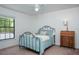 Comfortable bedroom with iron bed frame, ceiling fan, natural light, and dresser at 934 Deerwood Loop, Longwood, FL 32779