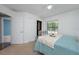 Light-filled bedroom showcasing a plush bed, a large window, and closet at 934 Deerwood Loop, Longwood, FL 32779