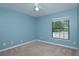 Cozy bedroom with light blue walls, a bright window, and neutral carpet at 934 Deerwood Loop, Longwood, FL 32779