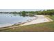 Lakeside community beach with calm waters, sandy shores, boat dock and picnic areas, enhancing lakeside living at 934 Deerwood Loop, Longwood, FL 32779