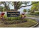 Elegant 'Sweetwater Beach' community sign amidst lush landscaping, creating a welcoming entrance to the neighborhood at 934 Deerwood Loop, Longwood, FL 32779