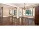 Bright and spacious dining room with dark floors and views of the pool area at 934 Deerwood Loop, Longwood, FL 32779