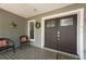 Charming front entrance featuring double doors with decorative glass and cozy seating at 934 Deerwood Loop, Longwood, FL 32779