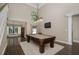 Bright game room with a pool table, mounted TV, and view into the dining area at 934 Deerwood Loop, Longwood, FL 32779