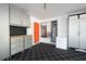 Garage featuring gray storage cabinetry with work bench and checkered floor at 934 Deerwood Loop, Longwood, FL 32779