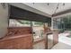 Patio kitchen with built-in grill, terracotta tiles, sink and mini fridge at 934 Deerwood Loop, Longwood, FL 32779