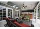 Covered patio featuring an outdoor kitchen, seating, and pool access at 934 Deerwood Loop, Longwood, FL 32779