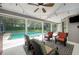 Covered patio with seating, ceiling fan, and views of the screened-in pool at 934 Deerwood Loop, Longwood, FL 32779