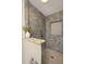Modern walk-in shower features stylish tilework, a built-in niche, and granite topped half wall at 934 Deerwood Loop, Longwood, FL 32779
