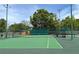 Well-maintained community tennis courts with lush landscaping and ample lighting for evening play at 934 Deerwood Loop, Longwood, FL 32779