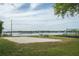 Community sand volleyball court by a lake, with playground and picnic tables, perfect for outdoor recreation at 934 Deerwood Loop, Longwood, FL 32779