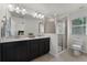 Bright bathroom features a double sink vanity, a walk-in shower, and a toilet at 9349 Sweet Maple Ave, Orlando, FL 32832