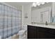Bathroom featuring a shower with a blue curtain, toilet and a vanity with granite countertop at 9349 Sweet Maple Ave, Orlando, FL 32832