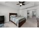 Bedroom features a tray ceiling, a ceiling fan, a wooden bed frame, and an ensuite bathroom at 9349 Sweet Maple Ave, Orlando, FL 32832