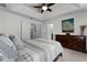 Bedroom featuring neutral bedding, tray ceiling, and artwork on the wall at 9349 Sweet Maple Ave, Orlando, FL 32832
