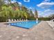 Community pool with lounge chairs and lush landscaping, perfect for relaxation and recreation at 9349 Sweet Maple Ave, Orlando, FL 32832