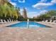 Inviting community pool surrounded by lounge chairs, landscaping, and a secure fence at 9349 Sweet Maple Ave, Orlando, FL 32832