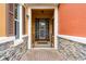 View of an attractive front door with stone decor, metal safety gate and brick walkway at 9349 Sweet Maple Ave, Orlando, FL 32832