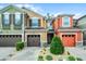 Colorful townhouses with garage, manicured shrubs and bushes, and paved driveway on a bright sunny day at 9349 Sweet Maple Ave, Orlando, FL 32832