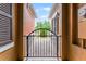 Wrought iron entry gate to home's front door and walkway surrounded by colorful stucco exteriors at 9349 Sweet Maple Ave, Orlando, FL 32832