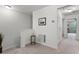 Hallway features a small decorative table, a vent, and framed artwork on the wall at 9349 Sweet Maple Ave, Orlando, FL 32832