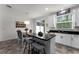 Open kitchen and dining area with an island, modern lighting, and sliding glass doors to the outdoors at 9349 Sweet Maple Ave, Orlando, FL 32832