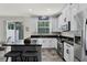 Modern kitchen featuring white cabinets, stainless steel appliances, and a center island with barstool seating at 9349 Sweet Maple Ave, Orlando, FL 32832