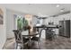 Open-concept kitchen and dining area with stainless steel appliances and abundant natural light at 9349 Sweet Maple Ave, Orlando, FL 32832