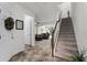 Entryway to spacious living room with carpeted floors, white walls, and staircase to upper level at 9349 Sweet Maple Ave, Orlando, FL 32832