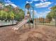Community playground with a slide and climbing structure, set against a backdrop of trees and sky at 9349 Sweet Maple Ave, Orlando, FL 32832