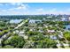 A broad aerial view of the city shows homes surrounded by mature landscaping with a downtown view at 1106 Ayrshire St, Orlando, FL 32803