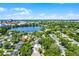 An aerial of the city showcases homes among mature trees with a beautiful lake view and downtown in the background at 1106 Ayrshire St, Orlando, FL 32803