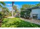 The backyard features an outdoor seating area, tropical landscaping, and a well maintained artificial lawn at 1106 Ayrshire St, Orlando, FL 32803