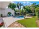 The backyard features a luxurious in-ground pool, outdoor seating, and well-manicured landscaping at 1106 Ayrshire St, Orlando, FL 32803