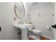 Classic bathroom featuring a pedestal sink and a modern toilet at 1106 Ayrshire St, Orlando, FL 32803