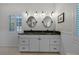Modern bathroom featuring a double vanity with elegant mirrors and fixtures at 1106 Ayrshire St, Orlando, FL 32803