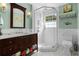Well-lit bathroom with a glass-enclosed shower, vanity, and modern fixtures at 1106 Ayrshire St, Orlando, FL 32803