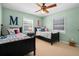 Spacious bedroom with two twin beds, complemented by natural light and modern ceiling fan at 1106 Ayrshire St, Orlando, FL 32803