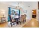 Dining room with hardwood floors, blue drapes and view to the kitchen at 1106 Ayrshire St, Orlando, FL 32803