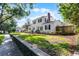 Charming two-story white home with black shutters and a brick chimney at 1106 Ayrshire St, Orlando, FL 32803