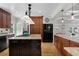 Well-appointed kitchen featuring a central island, granite countertops, and black refrigerator at 1106 Ayrshire St, Orlando, FL 32803