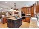 Gourmet kitchen features custom cabinetry, stainless steel appliances, and central island cooktop at 1106 Ayrshire St, Orlando, FL 32803