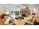 Inviting living room featuring a stone fireplace, built-in bookshelves, and patio doors at 1106 Ayrshire St, Orlando, FL 32803