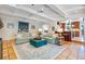 Bright and airy living room with terra cotta flooring and views into kitchen at 1106 Ayrshire St, Orlando, FL 32803