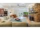 Cozy living room with exposed beam ceiling, stone fireplace, and access to the patio at 1106 Ayrshire St, Orlando, FL 32803
