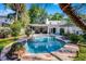 The backyard features a beautiful in-ground pool, lush landscaping, and an outdoor seating area at 1106 Ayrshire St, Orlando, FL 32803