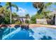 Inviting in-ground pool with a lush landscaped area, perfect for relaxing and entertaining guests at 1106 Ayrshire St, Orlando, FL 32803